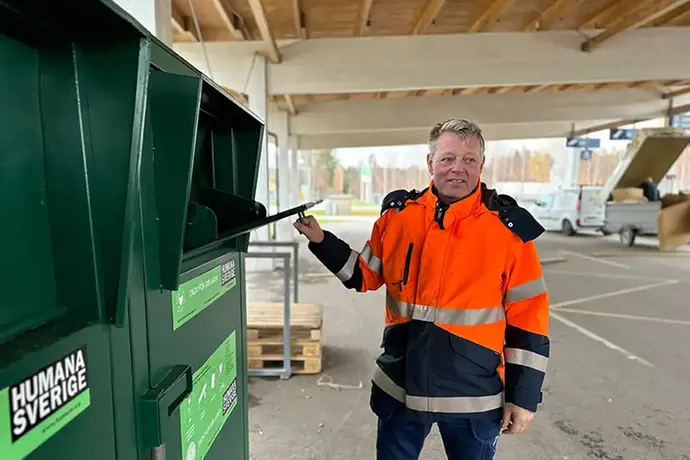 Medarbetare visar boxar för textilinsamling